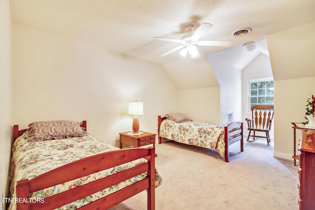 bedroom with vaulted ceiling, ceiling fan, a textured ceiling, and carpet floors