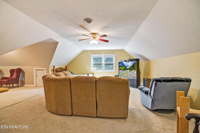 carpeted home theater room with ceiling fan and lofted ceiling