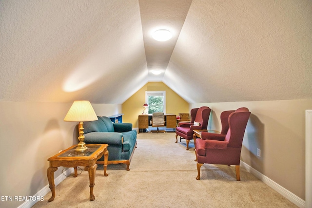 sitting room with a textured ceiling, light carpet, and lofted ceiling