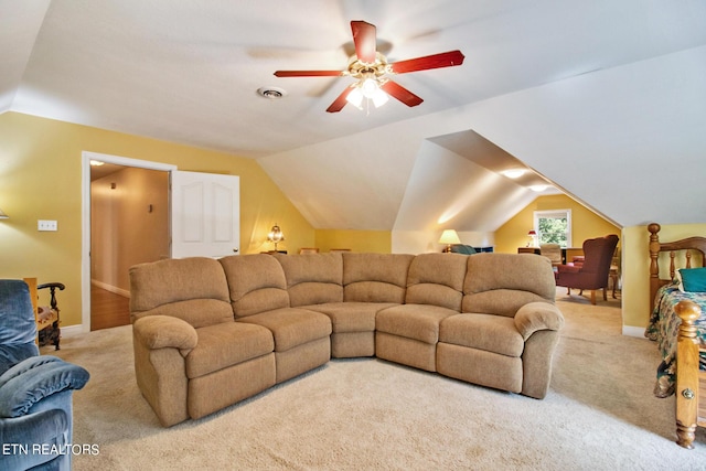 carpeted living room with ceiling fan and lofted ceiling