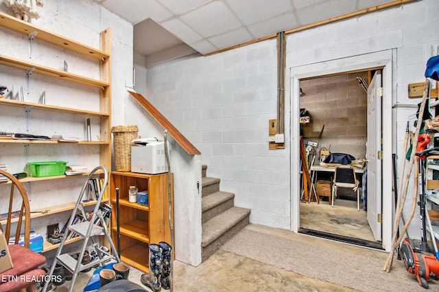 basement featuring a paneled ceiling