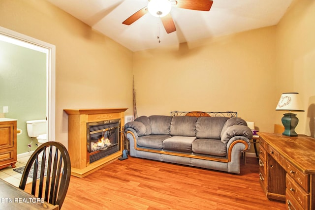 living room with ceiling fan and light hardwood / wood-style flooring