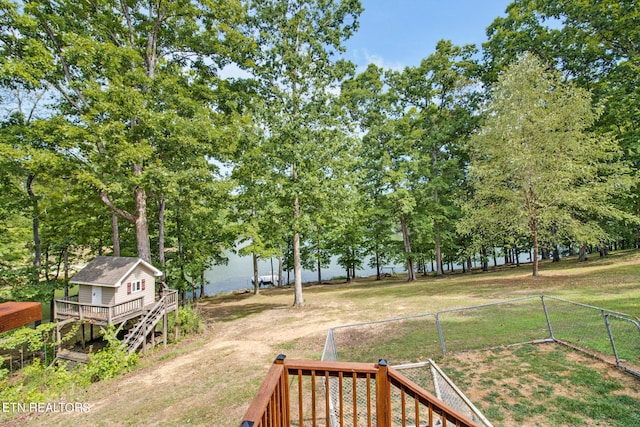 view of yard featuring a deck with water view