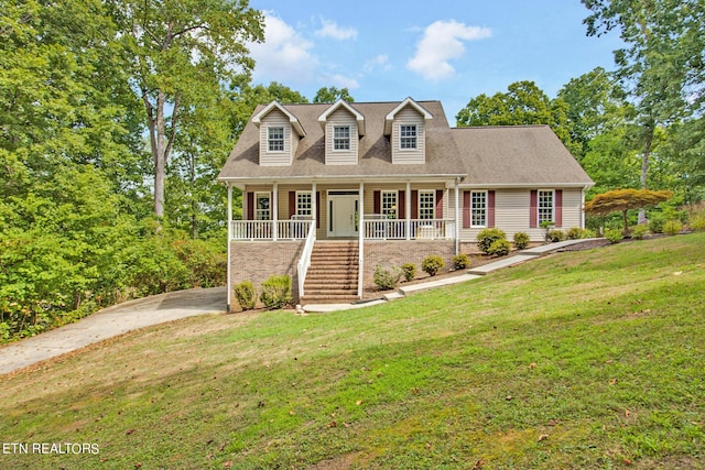 cape cod home featuring a front lawn and covered porch