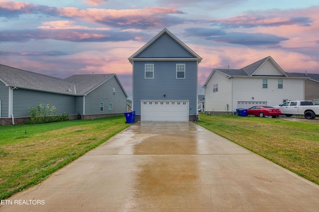 view of front facade featuring a garage and a yard