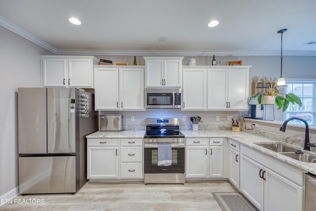 kitchen with white cabinetry, sink, and stainless steel appliances