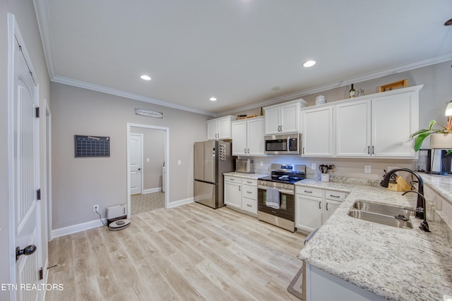 kitchen featuring sink, crown molding, white cabinets, and appliances with stainless steel finishes