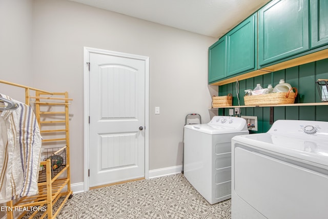 laundry room featuring cabinets, washing machine and dryer, and light tile patterned floors