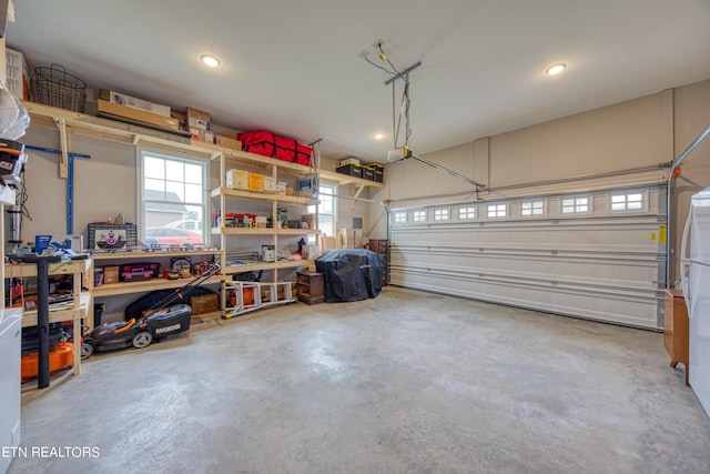 garage featuring a garage door opener and a workshop area