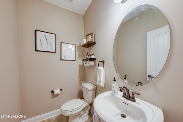 bathroom with toilet and sink