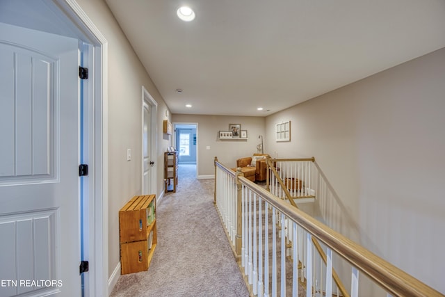 hall featuring light colored carpet