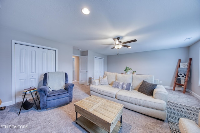 carpeted living room featuring ceiling fan