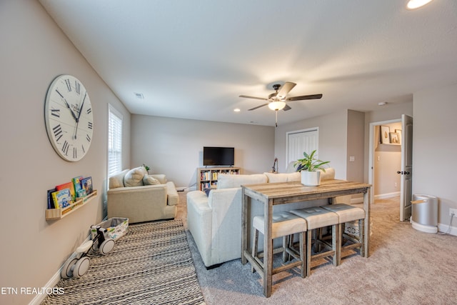 living room featuring ceiling fan and carpet floors