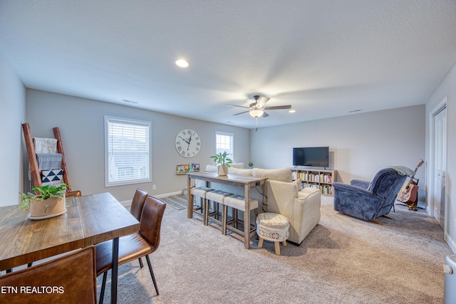 living room with light carpet and ceiling fan