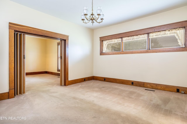 1227 N Main St, Sweetwater, TN 37874 - spare room featuring baseboards, visible vents, an inviting chandelier, and light colored carpet