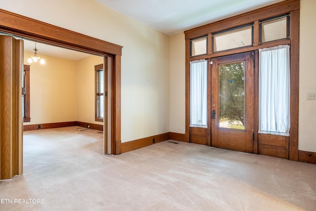 1227 N Main St, Sweetwater, TN 37874 - entryway with light carpet, baseboards, and a notable chandelier