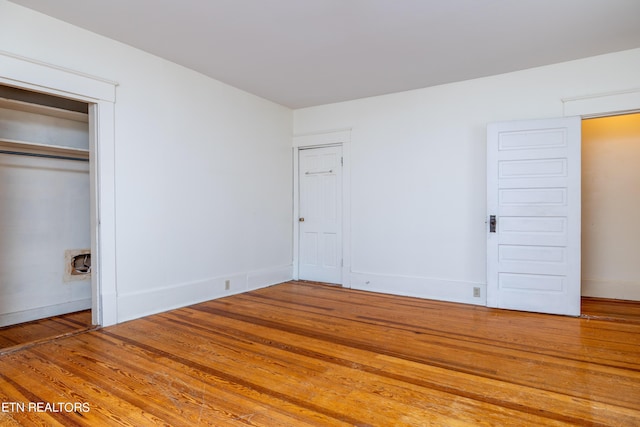 1227 N Main St, Sweetwater, TN 37874 - unfurnished bedroom with baseboards, wood finished floors, and two closets