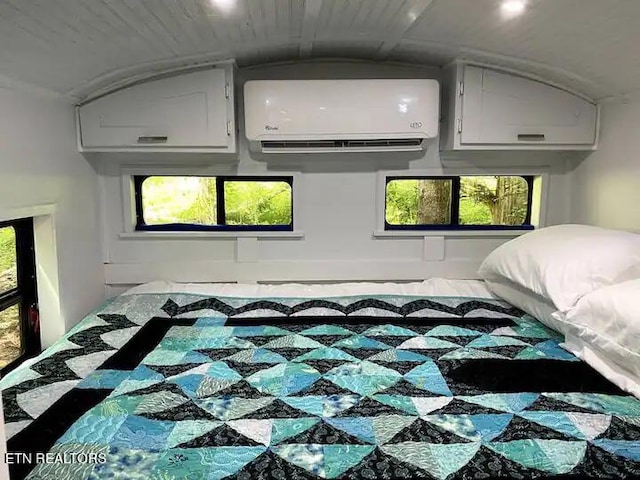 bedroom with a wall mounted air conditioner