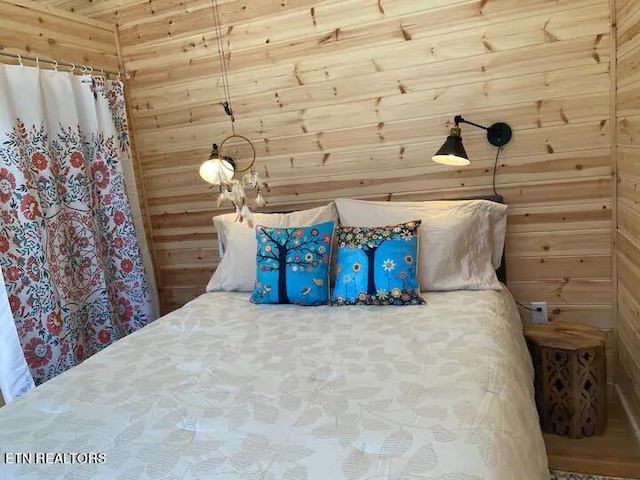 unfurnished bedroom featuring wood walls