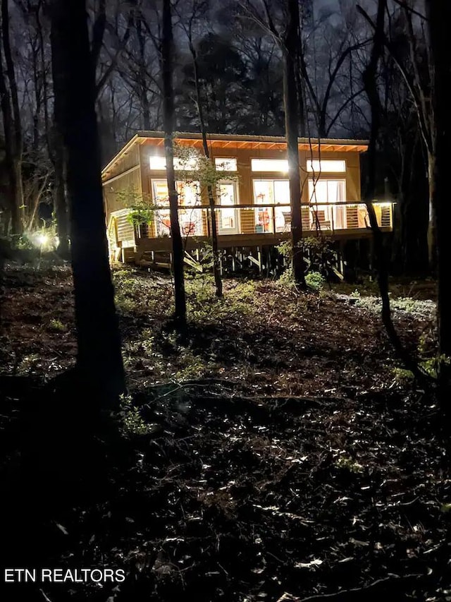 rear view of property featuring a wooden deck