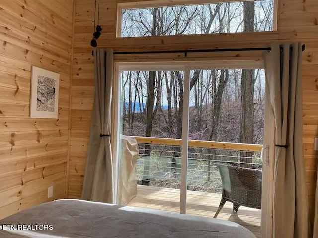 doorway to outside featuring wood walls