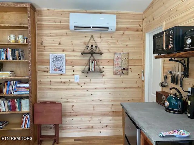 mudroom featuring an AC wall unit and wood walls