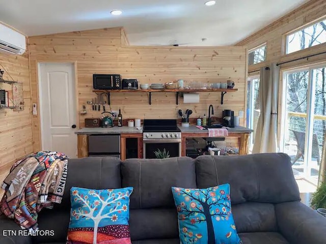 living room featuring an AC wall unit, sink, vaulted ceiling, and wood walls