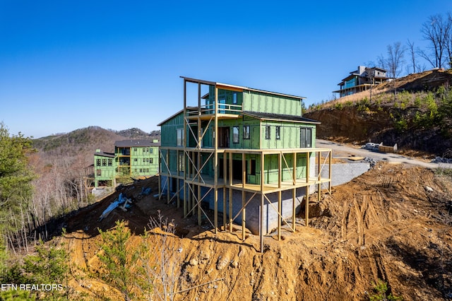 rear view of property featuring a mountain view
