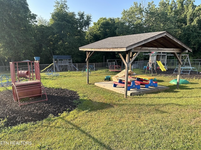 exterior space featuring playground community and fence