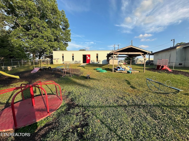 view of yard featuring fence and a playground