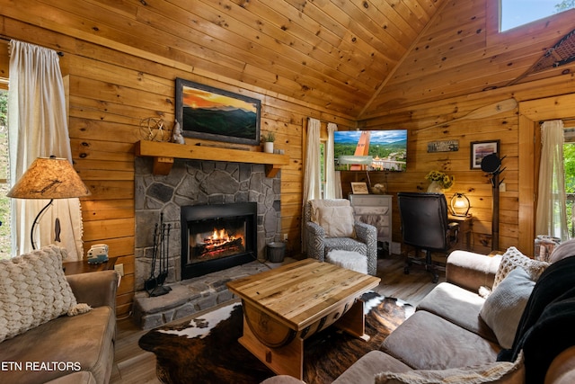 living room with a skylight, hardwood / wood-style floors, wooden ceiling, a fireplace, and high vaulted ceiling