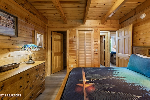 bedroom with dark wood-type flooring, wood ceiling, beam ceiling, and wood walls