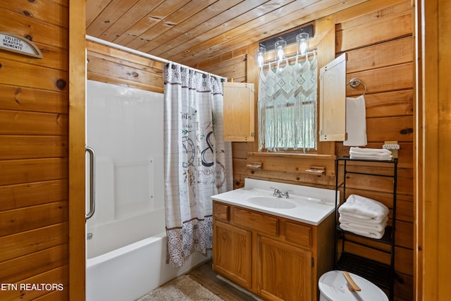 bathroom with vanity, wood walls, wood ceiling, and shower / tub combo with curtain