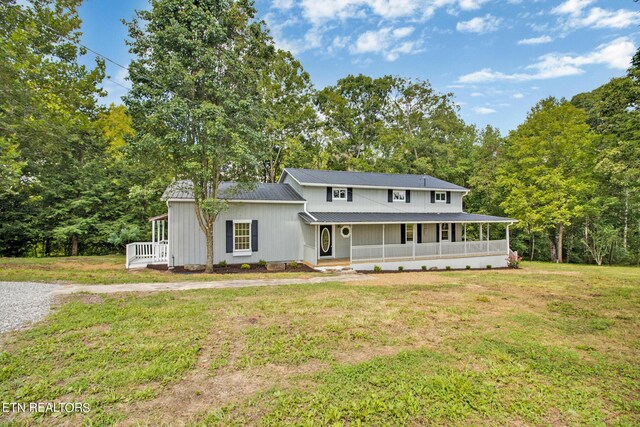 view of front of house featuring a front lawn and covered porch