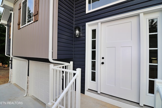 view of exterior entry with a garage