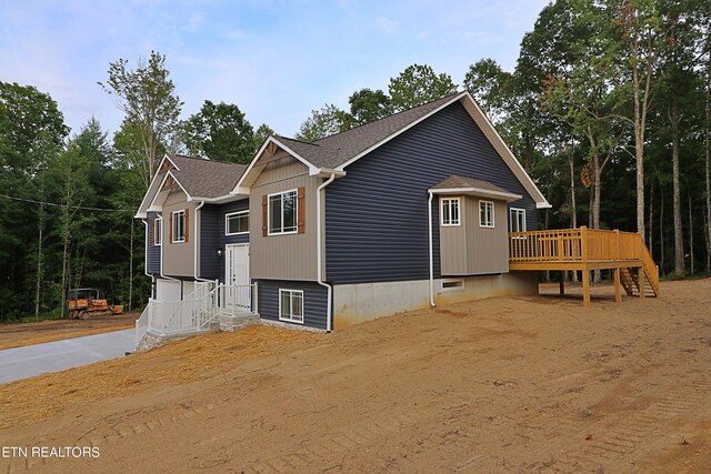 view of front of property with a wooden deck