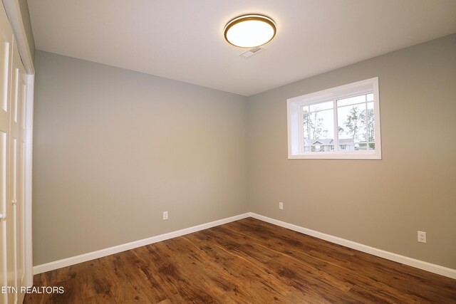 spare room with dark hardwood / wood-style floors