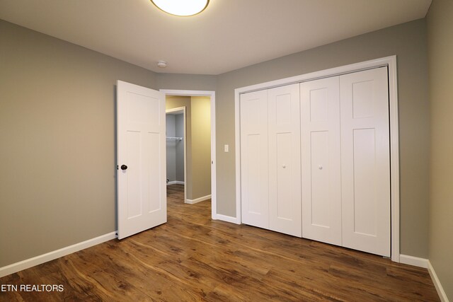 unfurnished bedroom with a closet and wood-type flooring