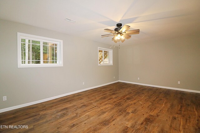 unfurnished room featuring hardwood / wood-style flooring, a wealth of natural light, and ceiling fan