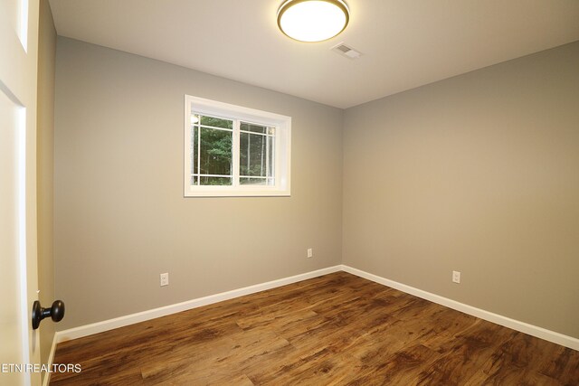 empty room with hardwood / wood-style flooring