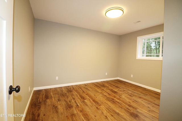 spare room with wood-type flooring