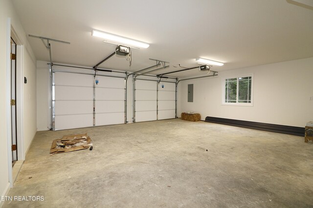 garage featuring electric panel and a garage door opener