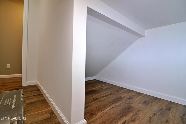 interior space featuring hardwood / wood-style flooring and vaulted ceiling