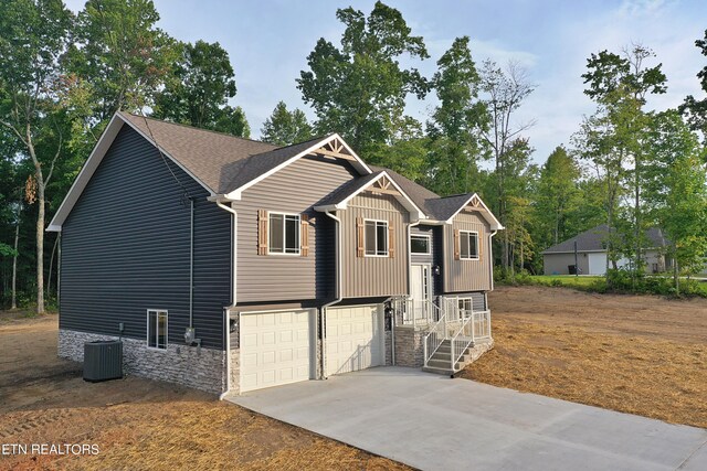 view of front of property with cooling unit and a garage