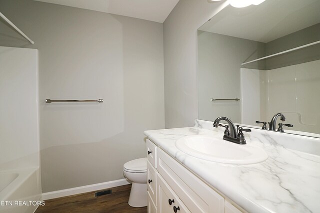 full bathroom featuring vanity, shower / bathing tub combination, wood-type flooring, and toilet