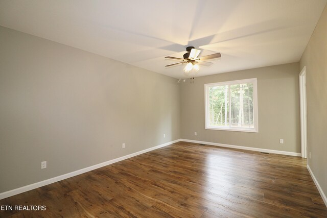 empty room featuring ceiling fan and dark hardwood / wood-style flooring