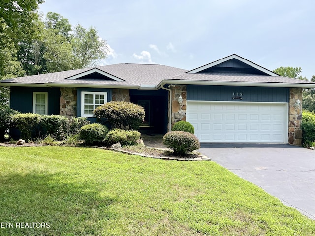 ranch-style house with a garage and a front yard