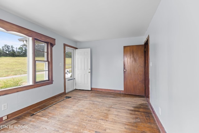 unfurnished room with hardwood / wood-style floors