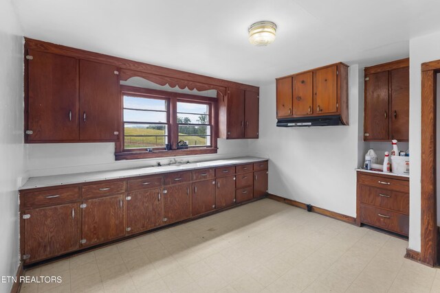 kitchen with range hood and light tile patterned floors