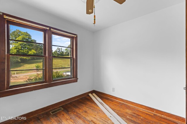 unfurnished room with hardwood / wood-style flooring, a healthy amount of sunlight, and ceiling fan